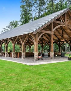 an outdoor covered pavilion in the middle of a park