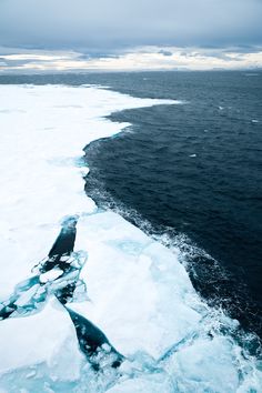 an ice floet on the ocean with dark clouds