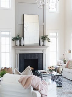 a living room filled with furniture and a fire place in the middle of a room