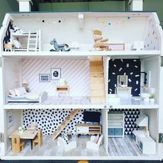 a doll house with furniture and accessories inside