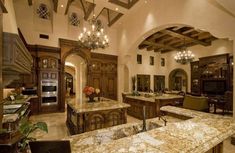 a large kitchen with marble counter tops and wooden cabinets