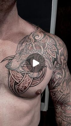 a man with tattoos on his chest is looking at the camera and has an eye in it