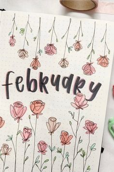 a notebook with the word february written on it next to some markers and pencils