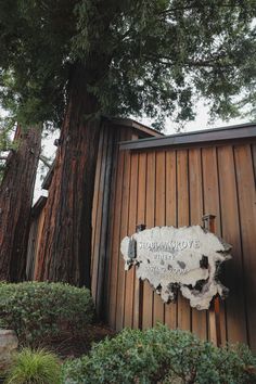 the entrance to redwood cove state park with two large trees in the background and a sign that says,