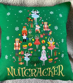 a green pillow with nutcracker characters on it