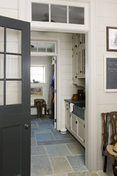 an open door leading to a kitchen and dining room