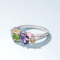 This stunning cluster ring is inspired by art and nature. Just like a blooming garden, the diverse colors of the stones represent the beauty and diversity of the world. The design aims to celebrate individuality and the unique beauty that each person possesses. Created in sterling silver, it features stones that are thoughtfully arranged on the band, creating a harmonious blend of colors and a captivating visual effect. Whether worn as a symbol of self-expression or a celebration of life's vibra Multicolor Multi-stone Birthstone Ring Fine Jewelry, Elegant Multicolor Multi-stone Birthstone Ring, Multicolor Flower Ring For Wedding, Multicolor Multi-stone Cluster Ring As Gift, Multicolor Birthstone Ring With Accent Stones, Fine Jewelry Multicolor Birthstone Ring With Gemstone Accents, Multicolor Fine Jewelry Cluster Ring For Anniversary, Multicolor Multi-stone Birthstone Ring For Wedding, Multicolor Cluster Ring For Anniversary