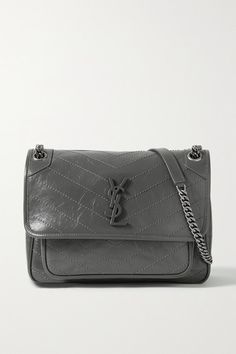 SAINT LAURENT's 'Niki' bag has been made in Italy from crinkled glossed-leather for a vintage feel and detailed with signature chevron stitching. It's embellished with a tonal 'YSL' plaque at the front and has adjustable chain straps. -- Dark-gray leather (Calf) - Snap-fastening front flap - Designer color: Storm - Comes with dust bag - Weighs approximately 2.2lbs/ 1kg - Made in Italy Ysl Grey Sunset Bag, Luxury Gray Bags, Ysl Metallic Bag, Ysl Demin Bag, Star Ysl Bag, Ysl Diamond Bag, Ysl Crinkle Bag, Ysl Kate Small Silver, Ysl Niki Bag Baby