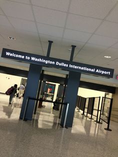 the entrance to washington dulls international airport with people walking through it and luggage bags on the ground