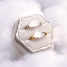 These handcrafted cloud rings are made using high quality Mother of Pearl which is believed to impart wisdom, integrity, and grace to its wearer. The clouds serve as a reminder to slow down and be present just like when you used to stare up at the sky and watch the clouds roll by. They are also known to be a sign of good fortune and more optimistic days to come.  Product Details 11x7mm Cloud 2mm Band Width Each gemstone has been carefully carved and then wire wrapped using tarnish resistant Silv Cloud Ring, White Cloud, Handcrafted Rings, Pearl Gemstone, Cute Rings, Polish Jewelry, The Clouds, Cleaning Jewelry, Gold Plated Jewelry