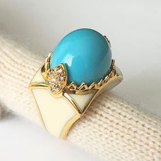 UNIQUE VINTAGE BY CRISTINA SABATINI 18k GOLD PLATED, CZ, RESIN RING SIZE 7 Suppose you are looking for a statement piece of jewelry that combines elegance, color, and sparkle. In that case, you might want to check out the CRISTINA SABATINI 18k Gold plated, CZ, turquoise cabochon resin ring.  This ring is a stunning creation by Cristina Sabatini, a designer known for her gold-plated, precious stone, and sterling silver creations. The ring features a large turquoise-like resin cabochon, and cubic Gold Luxury Enamel Ring With Cabochon, Gold Luxury Enamel Cabochon Ring, Elegant Gold Turquoise Cabochon Ring, Luxury Gift Enamel Ring With Cabochon, Oval Turquoise Enamel Jewelry, Turquoise Oval Enamel Jewelry, Resin Cabochon, Cabochon Ring, Resin Ring