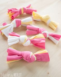 several different colored hair bows on a table