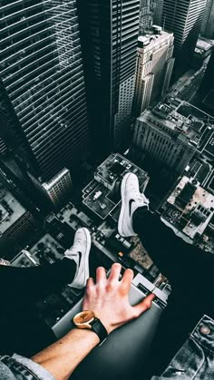 a person standing on top of a building with their hands in the air