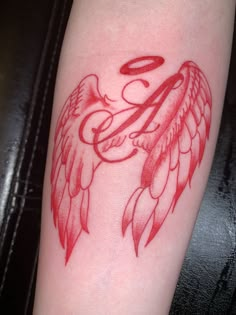 a red tattoo with an angel design on it's arm and the letter e