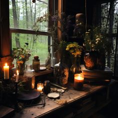 a window sill filled with lots of plants and candles