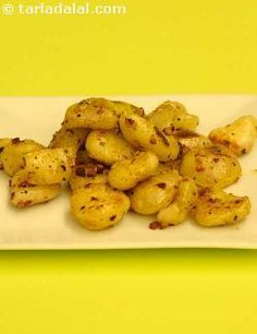 a white plate topped with potatoes on top of a yellow table