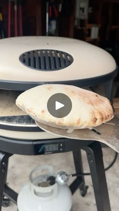 a pizza being grilled on top of an outdoor grill