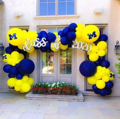 a balloon arch decorated with blue and yellow balloons