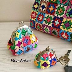 two crocheted purses and keychains on a table with the name fusun arkan