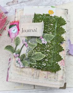 a close up of a piece of cloth with flowers on it and a tag that says journal