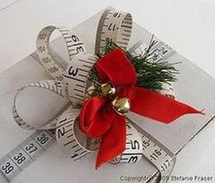 a measuring tape wrapped around a red bow