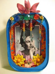 a blue frame with flowers and an image of fridace in the middle is shown