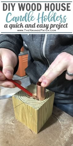 a person using a knife to cut into a piece of wood with the words diy wood house candle holders