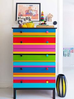 a colorful chest of drawers in a room