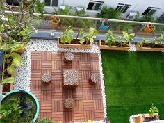 an overhead view of a patio with potted plants and seating area on the ground