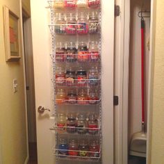 a pantry door is open and there are jars on the shelves