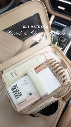 the inside of a car with an open case containing cosmetics and personal care items in it