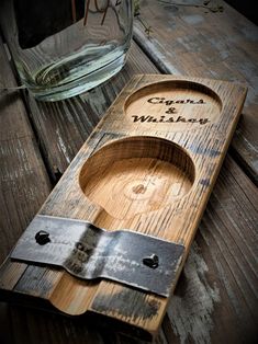 a wooden box with a knife and some glass on the table next to it that says grandma's wildflowers