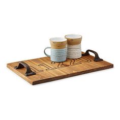 two mugs sitting on top of a wooden tray