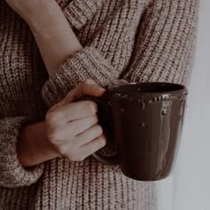 a person holding a coffee cup in their hands