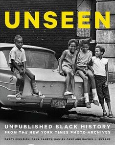 an open book with children sitting on the hood of a car in front of it