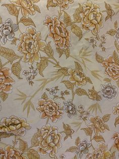 an image of a flowery fabric with many flowers on the back and yellow leaves