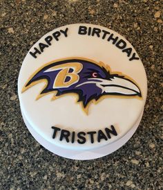 a birthday cake with the baltimore ravens logo on it and happy birthday written in white frosting