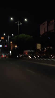 an empty city street at night with lights on