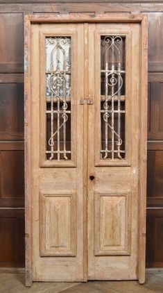 an old wooden double door with iron bars