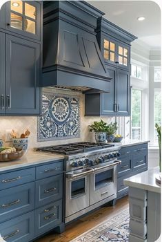 a kitchen with blue cabinets and stainless steel stove top oven in the center, surrounded by potted plants