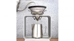 a stainless steel coffee pot being filled with liquid