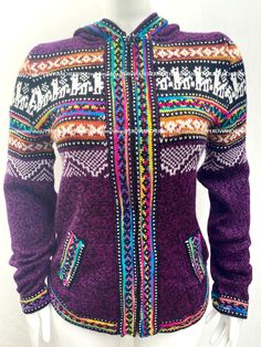 a mannequin wearing a purple sweater with multicolored patterns