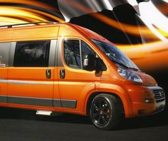 an orange van is parked in front of a black and white background with swirls