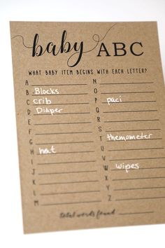 the baby abc game is shown on a piece of brown paper with black lettering and handwritten