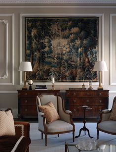 a living room filled with furniture and a tapestry on the wall