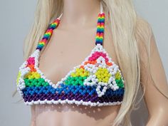 Last chance for this item. Once this sells out, I will no longer be making it anymore. This kandi bra is made with rainbow and white pony beads. This Item glows under the blacklight! This kandi bra ties around the neck and back to adjust easily. This Item is pre made and is ready to be shipped. Perfect for any event! You will get lots of compliments in this unique wearable art! Stand out at your next event! Edm festival  Raves Party  Rave outfit  Festival outfit Pride Mardi gras Glow party Rave Y2k Style Festival Halter Top, Rave Crop Top For Music Festival, Kandi Corset, Rave Pacifier Kandi, Rave Kandi Necklace, Kandi Bra, Rave Bras Summer, Bead Bra, Rave Outfits Edc