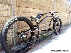 an old fashioned bicycle is parked against a wall