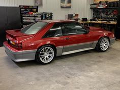 a red sports car parked in a garage