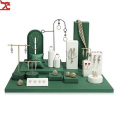 an assortment of jewelry is displayed on a green table