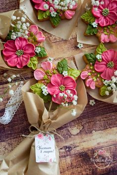 some pink and green flowers are tied to brown paper